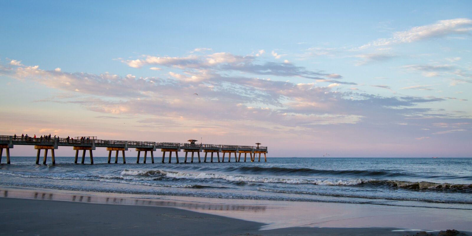 Sunset over Atlantic ocean with pier